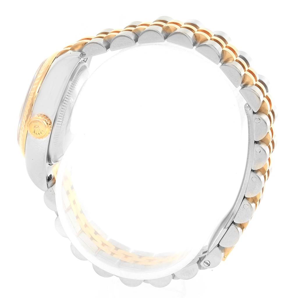 This image shows a side view of a Rolex Datejust 179173 Women's Steel and Gold (two tone) Black Dial 179173 Women's Steel and Gold (two tone) Black Dial watch, highlighting its gold crown and two-tone bracelet.