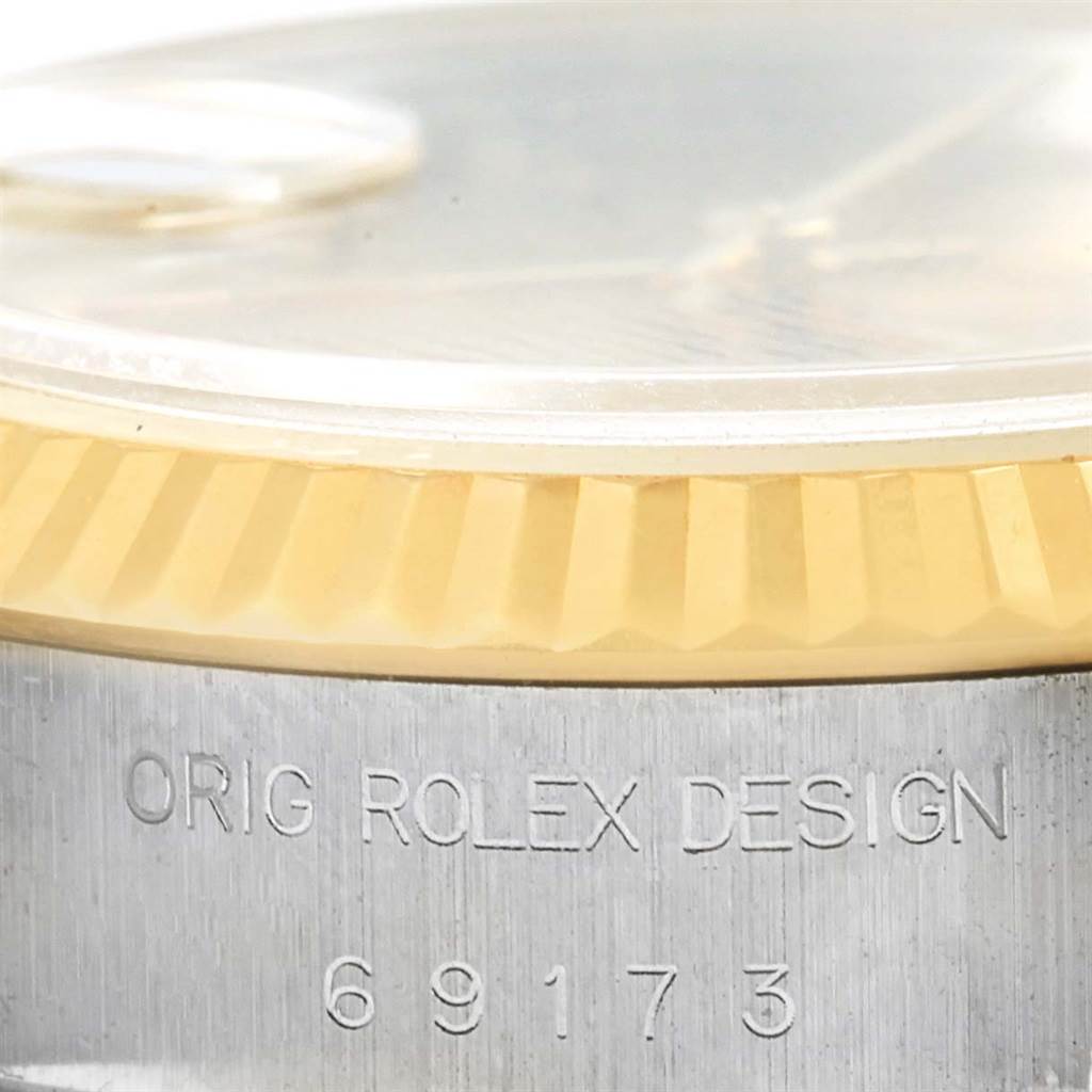 This is a close-up angle showing the bezel and case side of the Rolex Datejust 69173 Women's Stainless Steel Champagne Dial 69173 Women's Stainless Steel Champagne Dial model with inscription and reference number 69173.