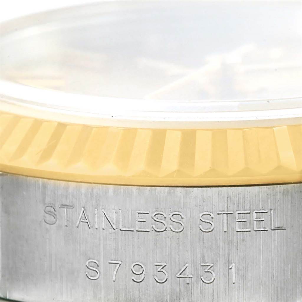 This image showcases the side angle of a Rolex Datejust 69173 Women's Stainless Steel Champagne Dial 69173 Women's Stainless Steel Champagne Dial watch, highlighting the bezel and engraved stainless steel case.