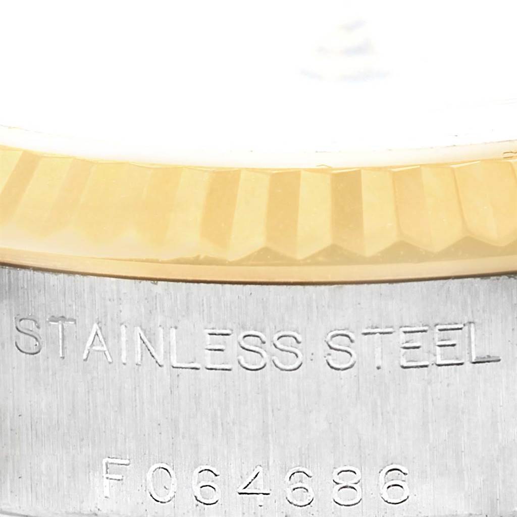 Close-up view of the Rolex Datejust 79173 Women's Steel and Gold (two tone) White Dial 79173 Women's Steel and Gold (two tone) White Dial model's fluted bezel and engraved stainless steel case back.