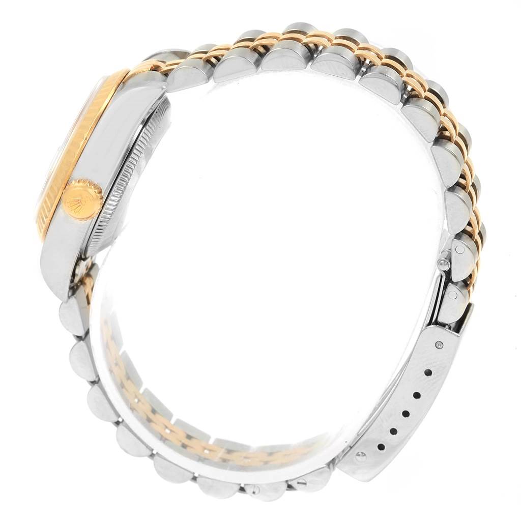 The image shows a side profile of a Rolex Datejust 79173 Women's Stainless Steel Silver Dial 79173 Women's Stainless Steel Silver Dial watch, highlighting its gold crown, stainless steel case, and two-tone Jubilee bracelet.