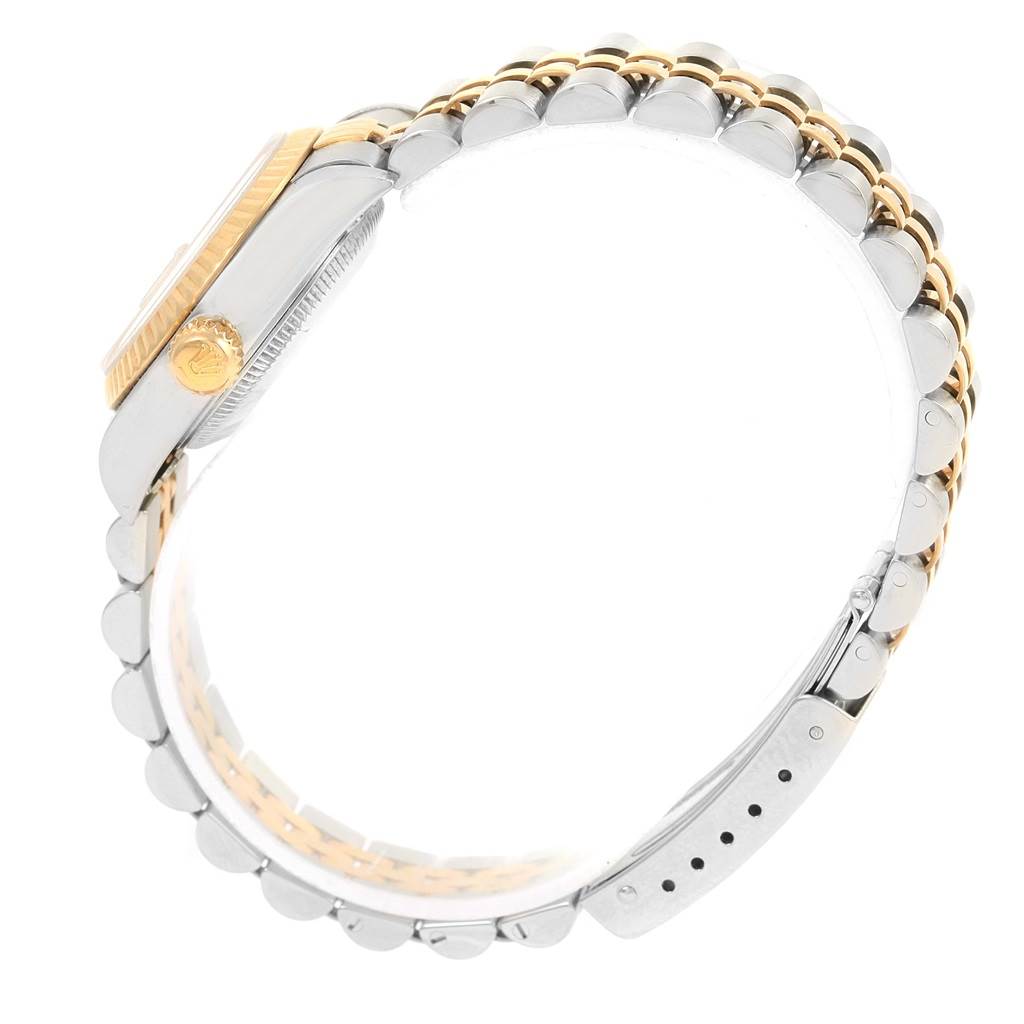 This image shows a side view of the Rolex Datejust 79173 Women's Steel and Gold (two tone) Beige Dial 79173 Women's Steel and Gold (two tone) Beige Dial, highlighting its gold bezel and two-tone bracelet.