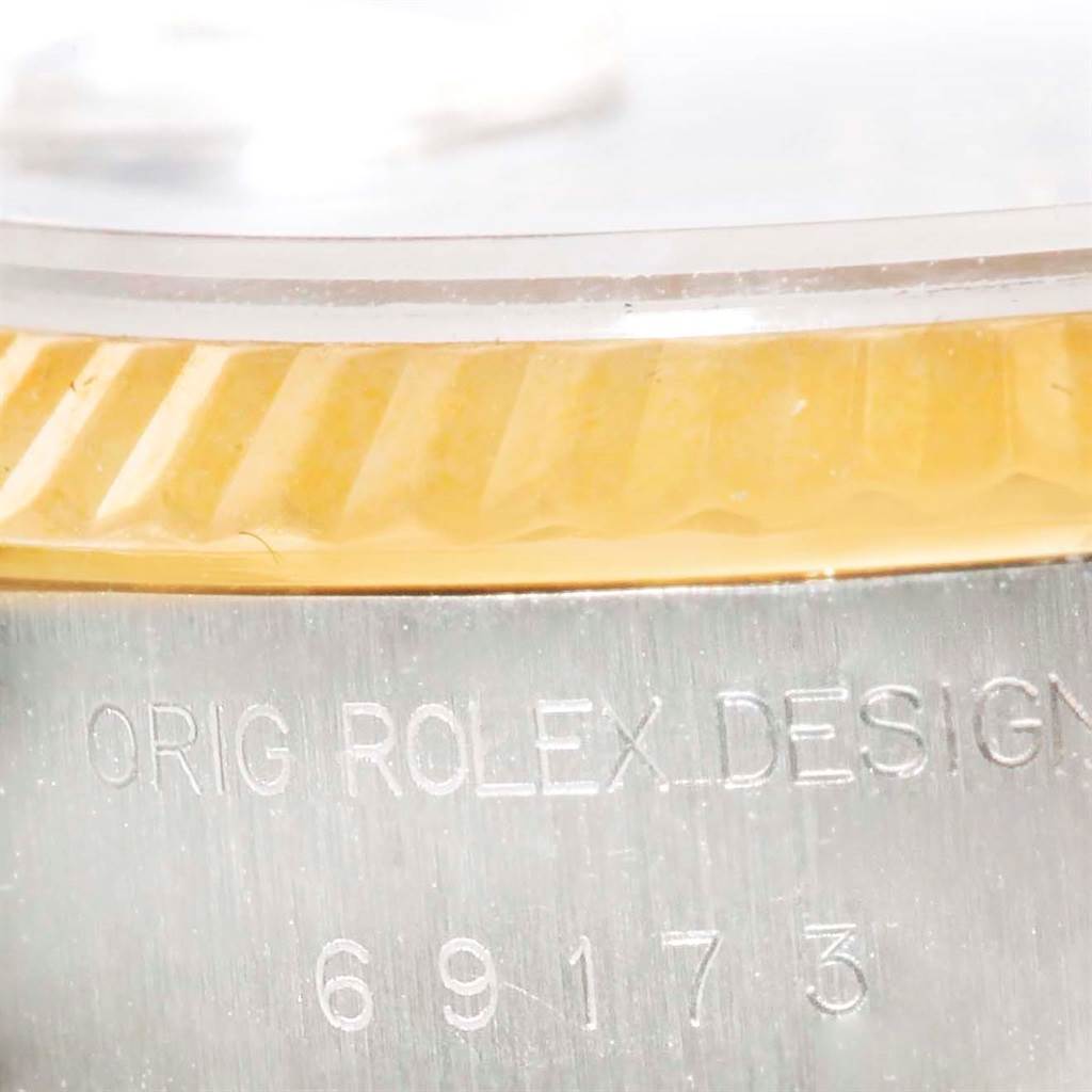 Close-up shot of the side of a Rolex Datejust 69173 Women's Stainless Steel White Dial 69173 Women's Stainless Steel White Dial showing the edge of the bezel and part of the engraved serial number.