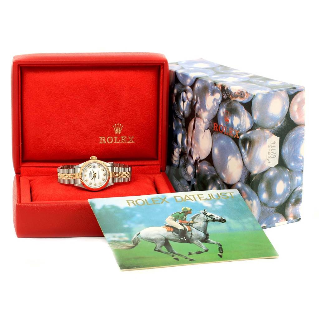 This image shows a Rolex Datejust 69173 Women's Stainless Steel White Dial 69173 Women's Stainless Steel White Dial watch displayed in its box with the outer packaging and a booklet in the foreground.