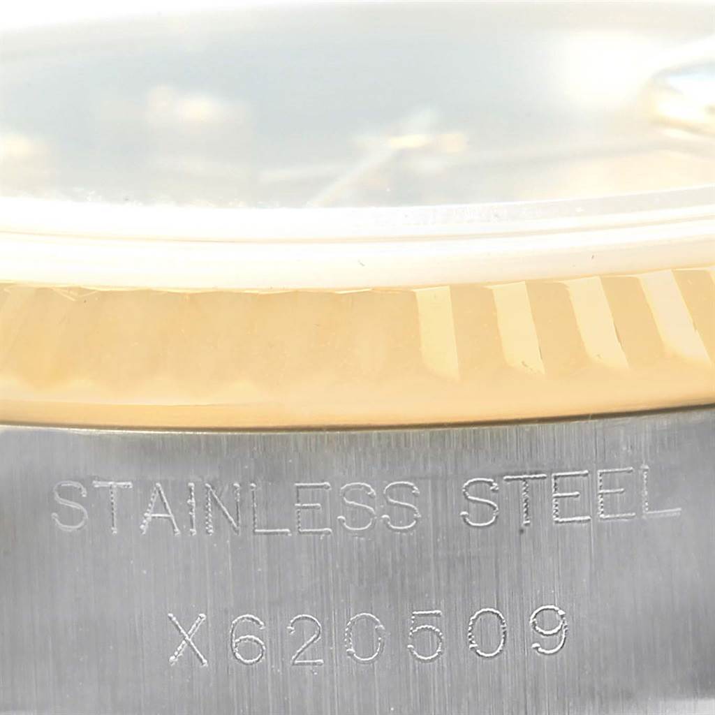 This close-up image of the Rolex Datejust 69173 Women's Stainless Steel Champagne Dial 69173 Women's Stainless Steel Champagne Dial watch shows its stainless steel casing and part of the bezel.