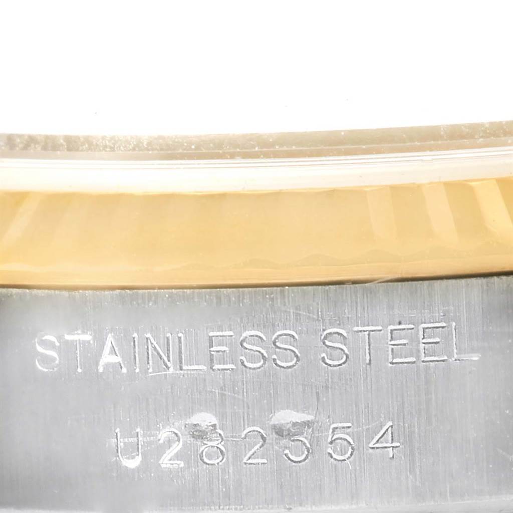 This image shows a close-up of the case side of a Rolex Datejust 69173 Women's Stainless Steel White Dial 69173 Women's Stainless Steel White Dial watch, featuring the stainless steel engraving and serial number.