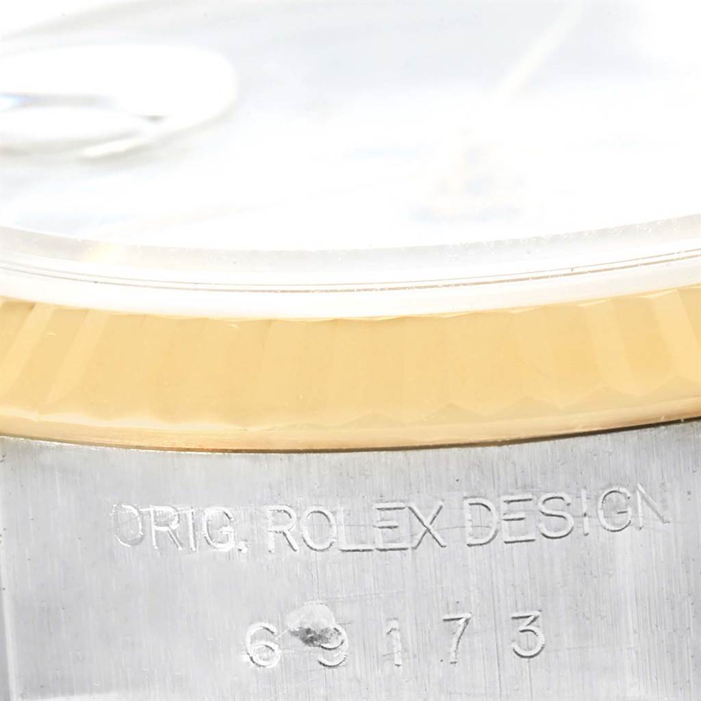 This image shows a close-up of the case and bezel of a Rolex Datejust 69173 Women's Stainless Steel White Dial 69173 Women's Stainless Steel White Dial watch, featuring the inscription "ORIG. ROLEX DESIGN" and the model number.