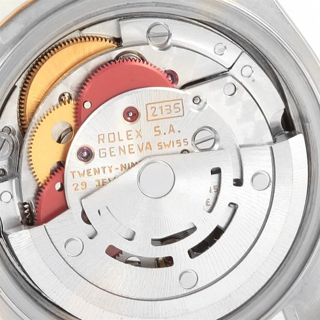 The image shows a close-up of the Rolex Datejust 69173 Women's Stainless Steel Champagne Dial 69173 Women's Stainless Steel Champagne Dial watch movement, showcasing the gears and mechanical parts.