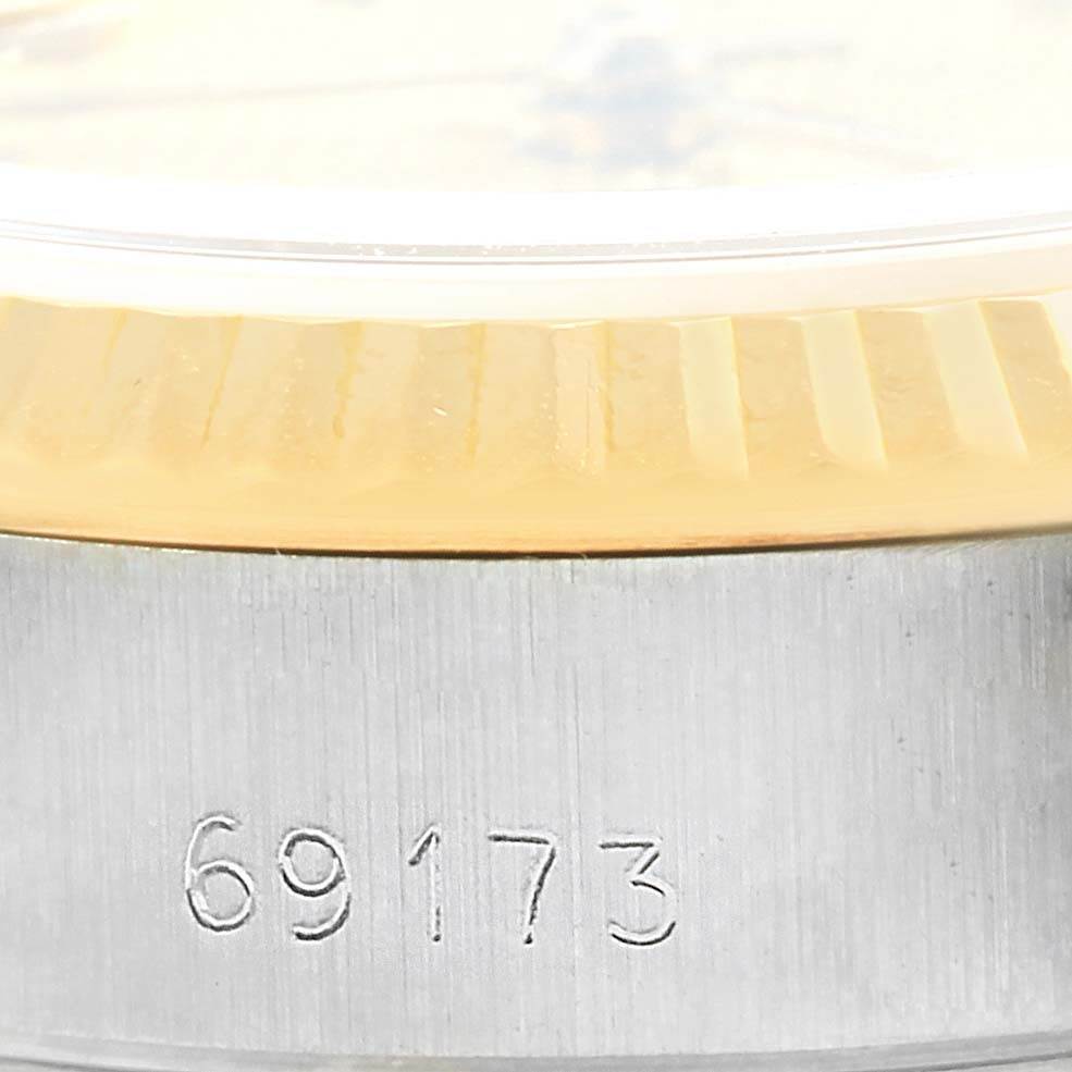 This image shows a close-up of the Rolex Datejust 69173 Women's Stainless Steel Champagne Dial 69173 Women's Stainless Steel Champagne Dial model's engraved case back edge and fluted bezel.