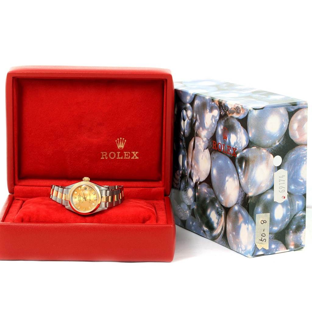The Rolex Datejust 69163 Women's Stainless Steel Champagne Dial 69163 Women's Stainless Steel Champagne Dial watch is shown from the front in a red box, next to its decorative outer box.
