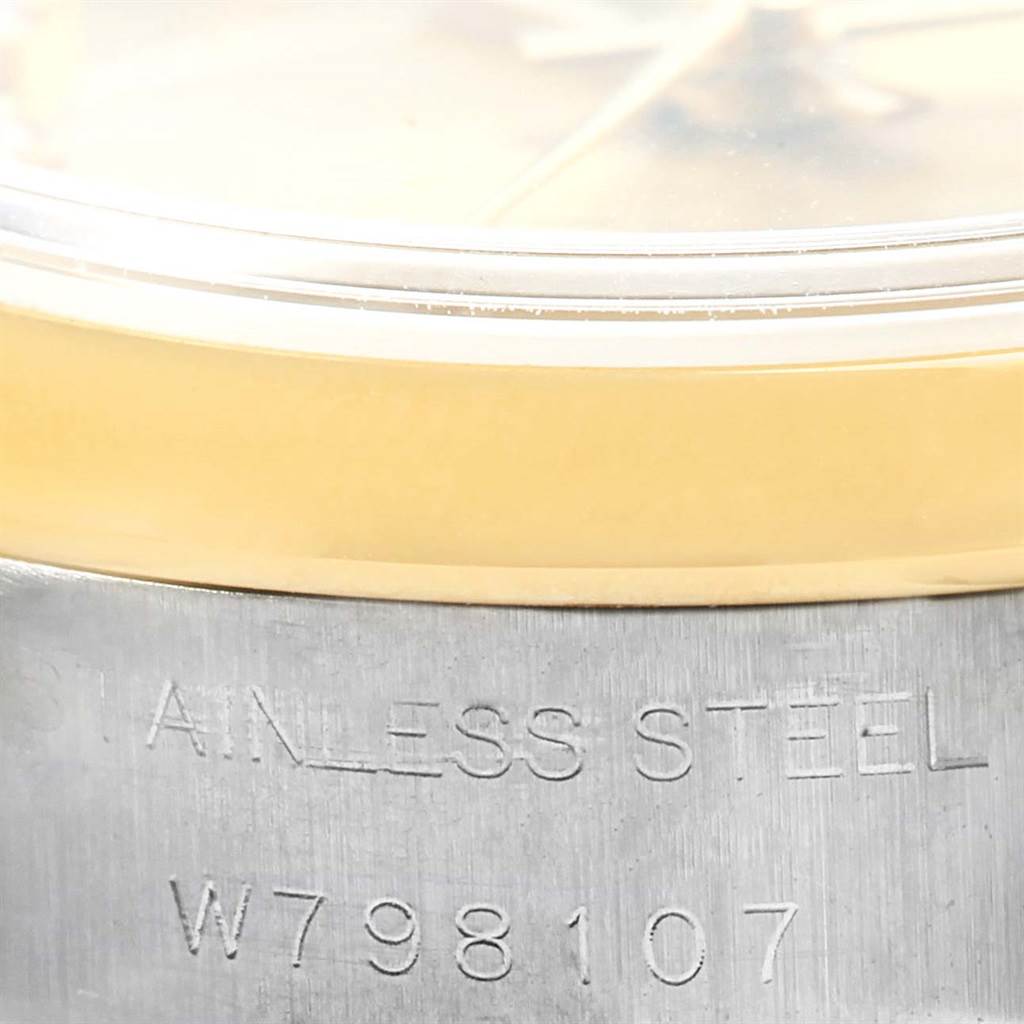 The image shows a close-up side angle of a Rolex Datejust 69163 Women's Stainless Steel Champagne Dial 69163 Women's Stainless Steel Champagne Dial watch, highlighting the stainless steel case with an engraved serial number.