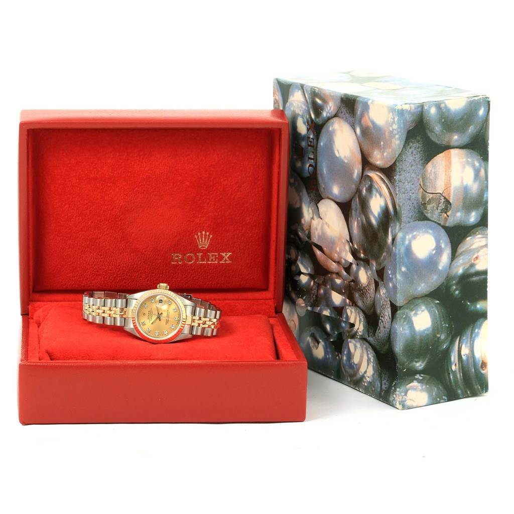 The Rolex Datejust 69173 Women's Stainless Steel Champagne Dial 69173 Women's Stainless Steel Champagne Dial watch is displayed in an open red box alongside its outer packaging.
