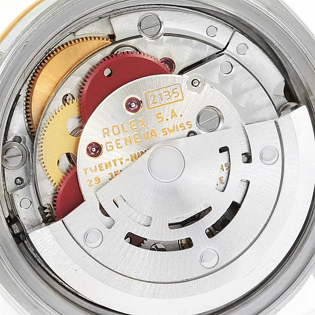 This close-up image of a Rolex Datejust 69173 Women's Steel and Gold (two tone) Blue Dial 69173 Women's Steel and Gold (two tone) Blue Dial watch shows its Swiss-made internal mechanisms and gears.