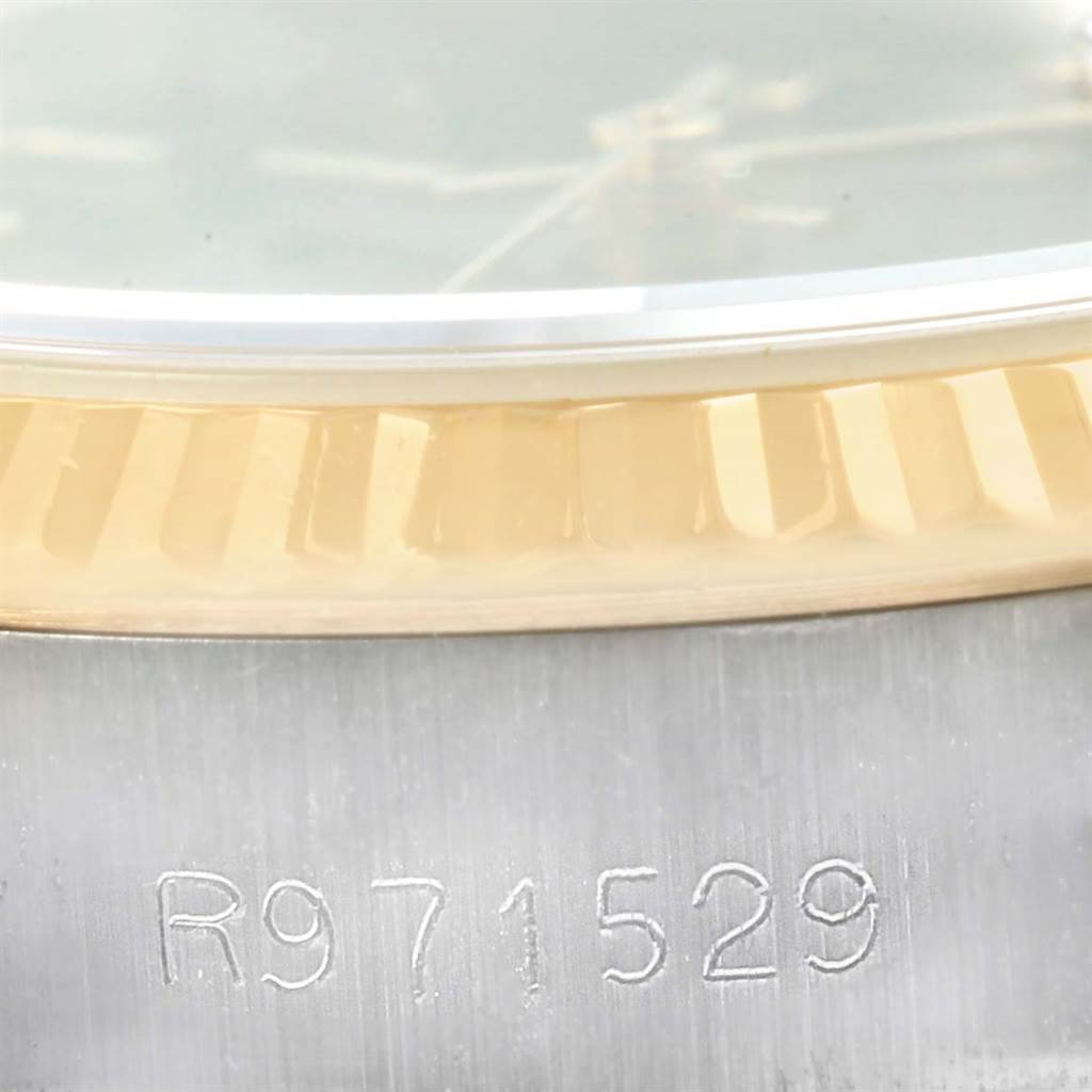 The image shows a close-up of the serial number and the fluted bezel of a Rolex Datejust 69173 Women's Steel and Gold (two tone) Blue Dial 69173 Women's Steel and Gold (two tone) Blue Dial watch.