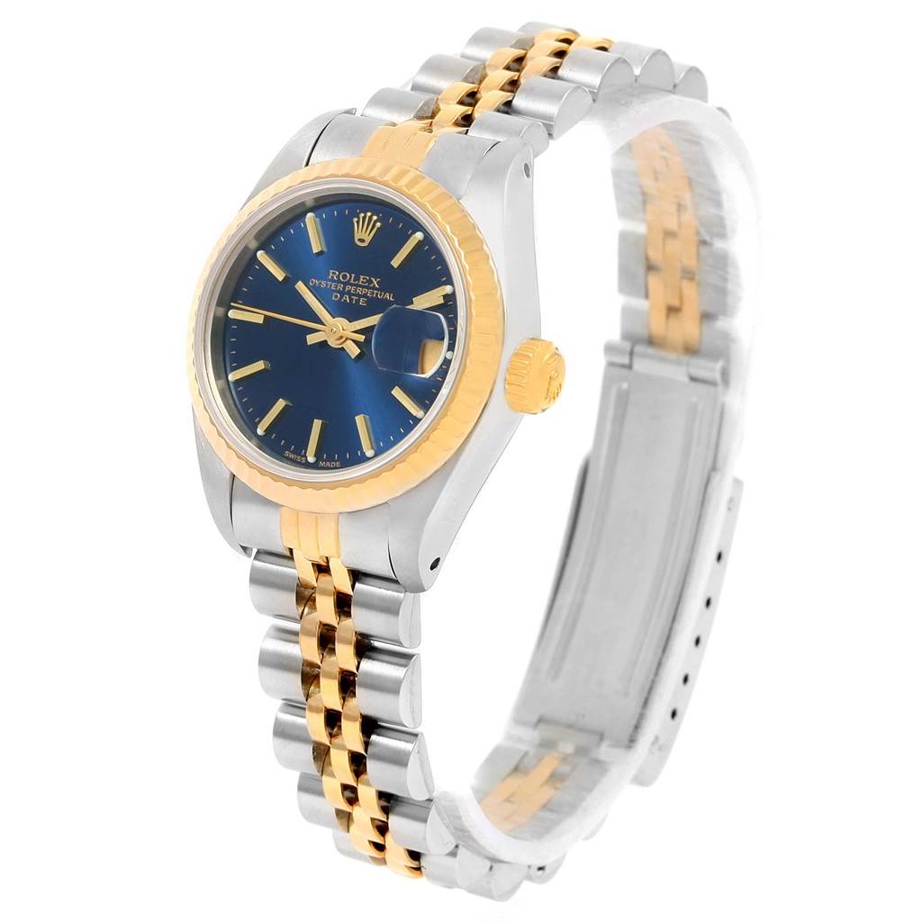 This image shows a Rolex Datejust 69173 Women's Steel and Gold (two tone) Blue Dial 69173 Women's Steel and Gold (two tone) Blue Dial watch at a three-quarter angle, highlighting its blue dial, yellow gold bezel, and two-tone bracelet.