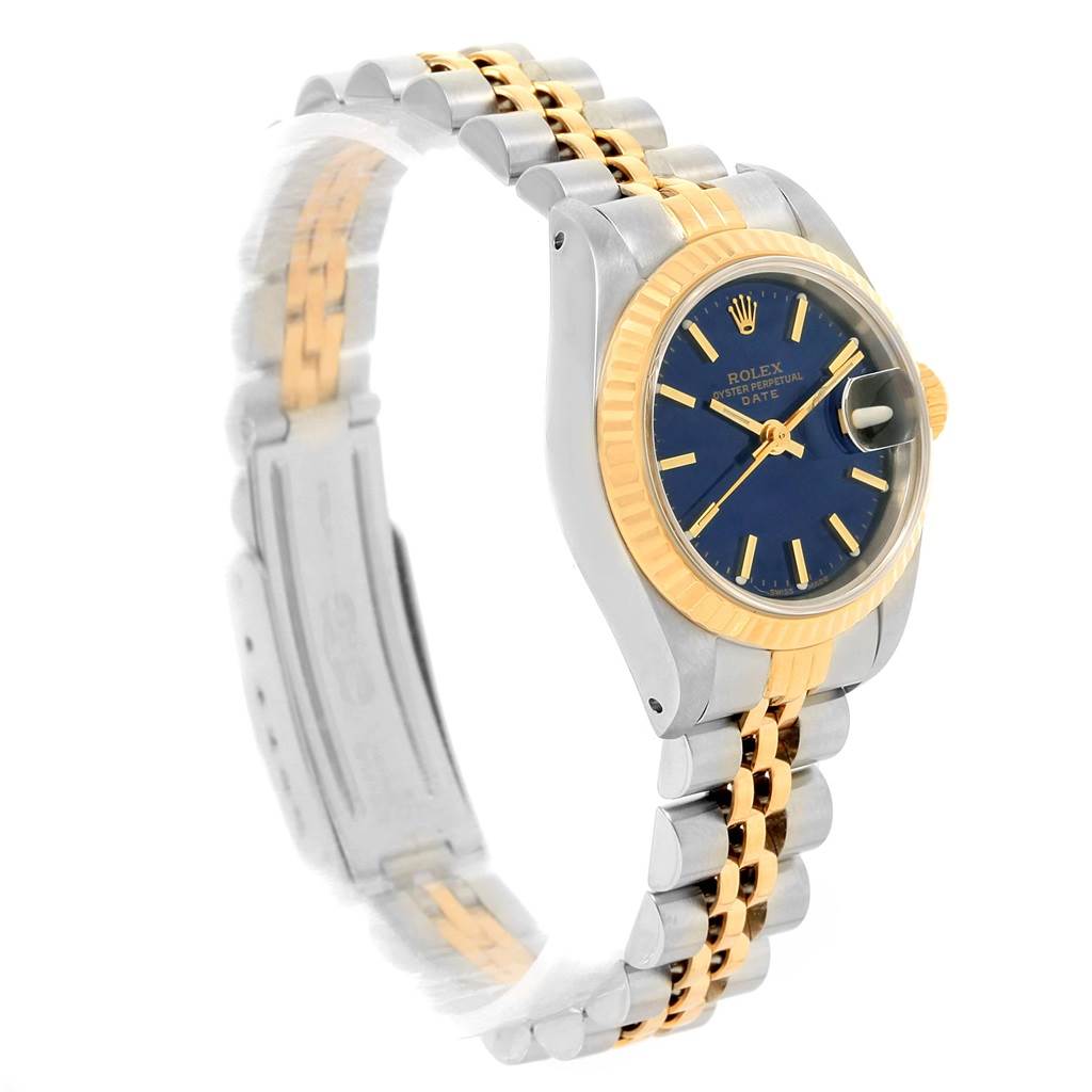 This Rolex Datejust 69173 Women's Steel and Gold (two tone) Blue Dial 69173 Women's Steel and Gold (two tone) Blue Dial watch is shown at a three-quarter angle, highlighting its blue dial, gold fluted bezel, and two-tone bracelet.