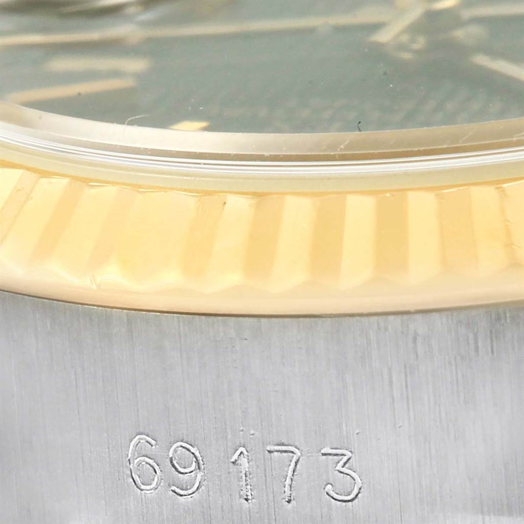 The image shows a close-up of the side of a Rolex Datejust 69173 Women's Stainless Steel Black Dial 69173 Women's Stainless Steel Black Dial watch, highlighting its fluted bezel and part of the casing with model number 69173.