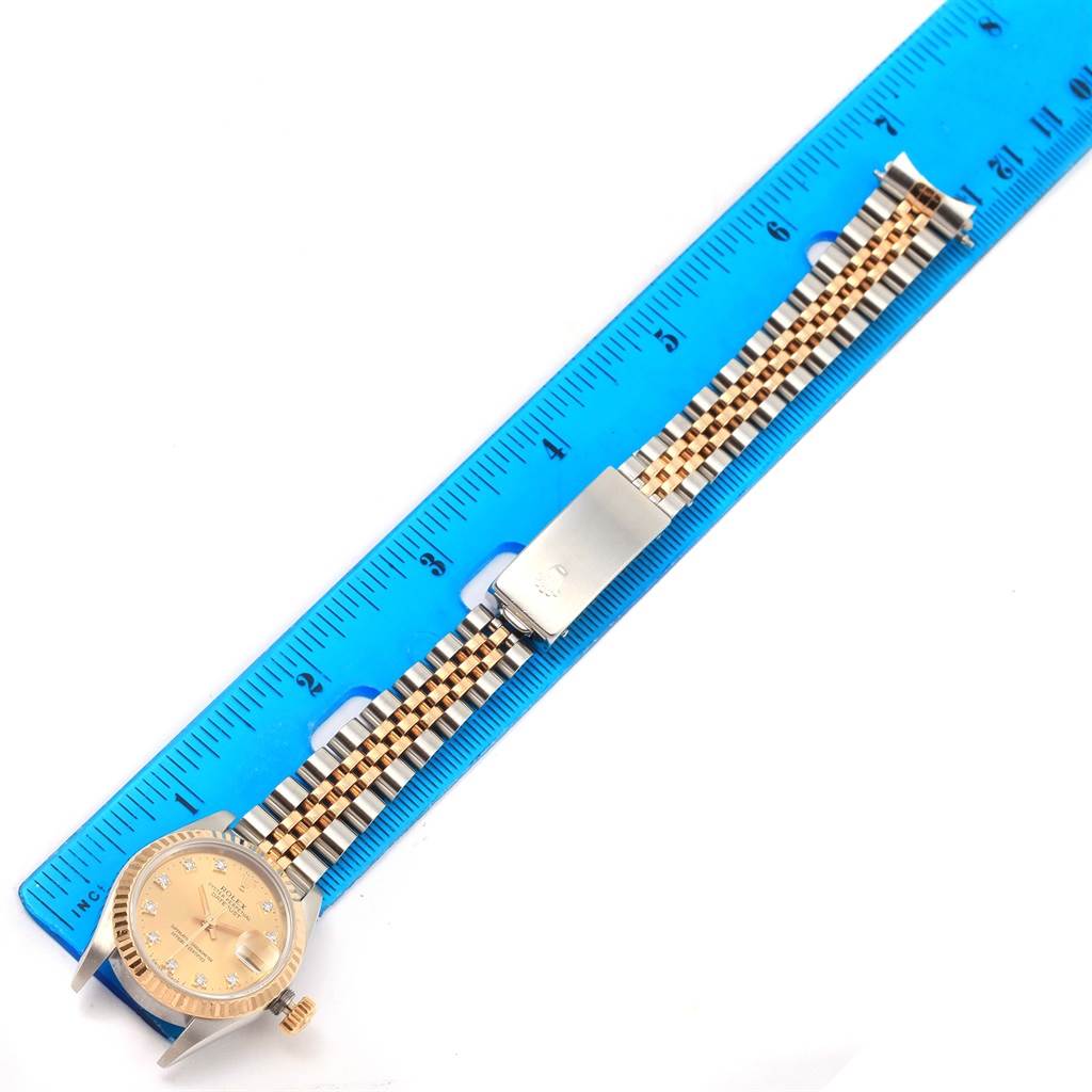 The image shows a Rolex Datejust 69173 Women's Stainless Steel Champagne Dial 69173 Women's Stainless Steel Champagne Dial watch laid flat with its band measured against a blue ruler.