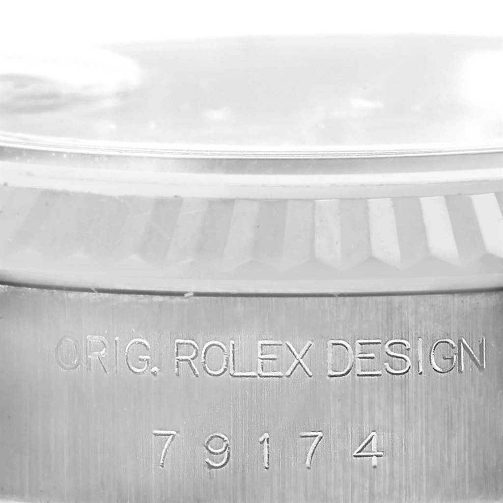 This image shows a close-up of the case side and bezel of the Rolex Datejust 79174 Women's Stainless Steel Silver Dial 79174 Women's Stainless Steel Silver Dial watch, revealing the model number and "ORIG. ROLEX DESIGN" engraving.