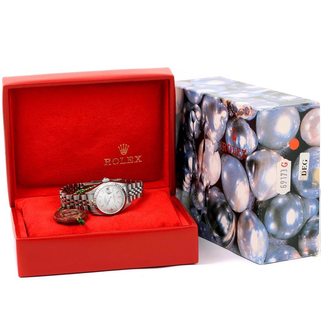 The image shows a Rolex Datejust 79174 Women's Stainless Steel Silver Dial 79174 Women's Stainless Steel Silver Dial watch from a frontal angle, inside a red watch box with an exterior decorative box beside it.