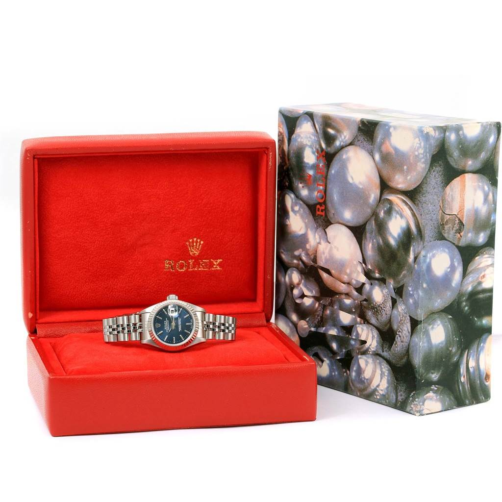 The Rolex Datejust 69174 Women's Stainless Steel Blue Dial 69174 Women's Stainless Steel Blue Dial watch is showcased frontally in a red Rolex case beside its decorative box.
