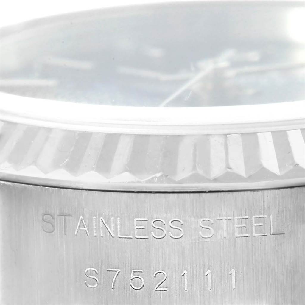 This image shows a close-up of the Rolex Datejust 69174 Women's Stainless Steel Blue Dial 69174 Women's Stainless Steel Blue Dial's stainless steel case and part of the bezel, highlighting the model number and material.