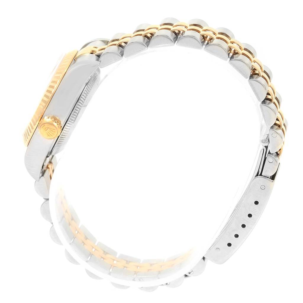 The image shows a side view of a Rolex Datejust 79173 Women's Steel and Gold (two tone) Champagne Dial 79173 Women's Steel and Gold (two tone) Champagne Dial watch featuring its crown, fluted bezel, and Jubilee bracelet.