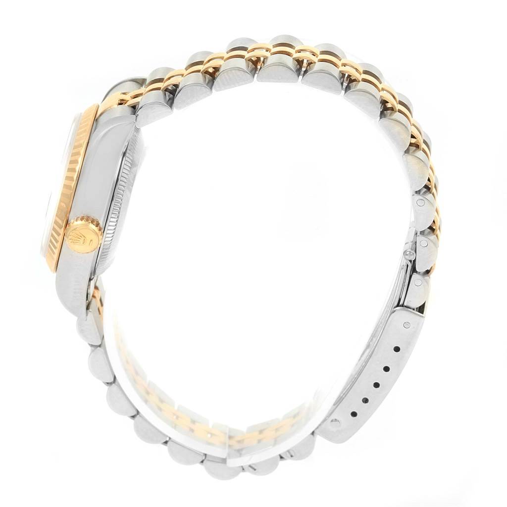 Side view of the Rolex Datejust 69173 Women's Stainless Steel Black Dial 69173 Women's Stainless Steel Black Dial watch showing the crown, case, and two-tone bracelet.