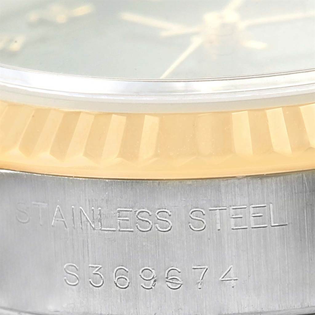 Close-up view of the bezel and case back of a Rolex Datejust 69173 Women's Stainless Steel Black Dial 69173 Women's Stainless Steel Black Dial watch, showing the "STAINLESS STEEL" engraving and serial number.