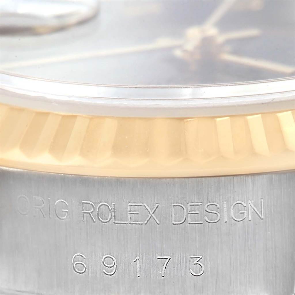 This image shows a close-up of the bezel and case side of the Rolex Datejust 69173 Women's Stainless Steel Black Dial 69173 Women's Stainless Steel Black Dial model, highlighting its fluted bezel and engraved reference number.
