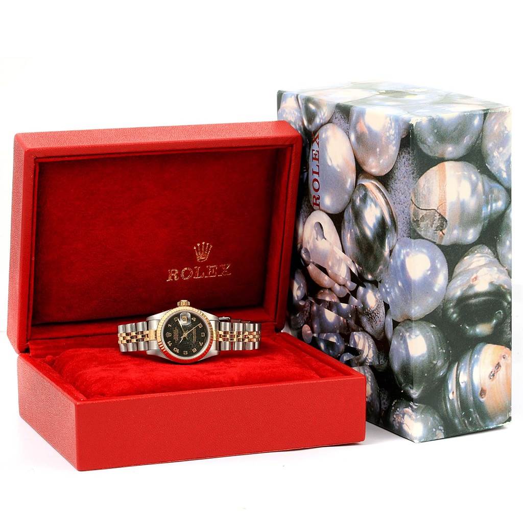 The Rolex Datejust 69173 Women's Stainless Steel Black Dial 69173 Women's Stainless Steel Black Dial watch is shown inside an open red box with a pearl-themed outer box packaging next to it.