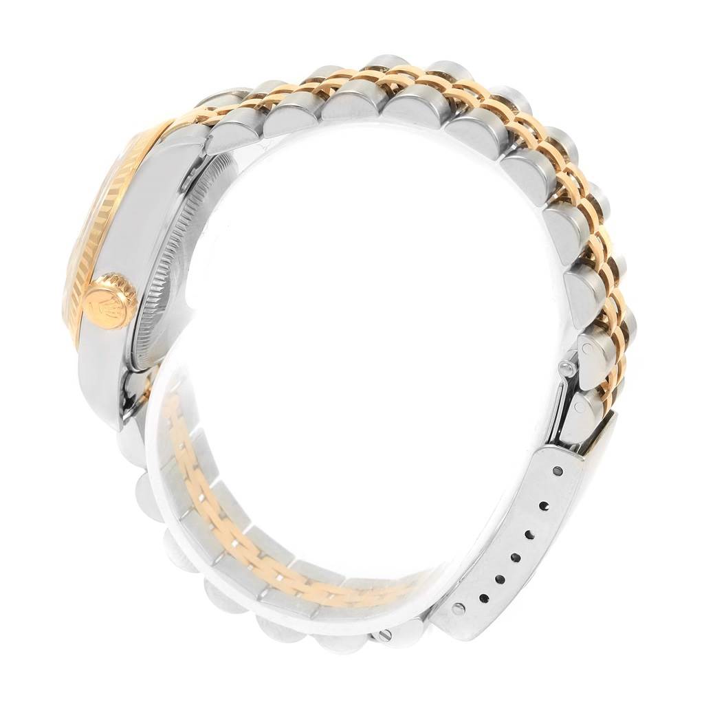 The image shows a side view of a Rolex Datejust 69173 Women's Stainless Steel Grey Dial 69173 Women's Stainless Steel Grey Dial watch, featuring its crown, case side, and two-tone jubilee bracelet.