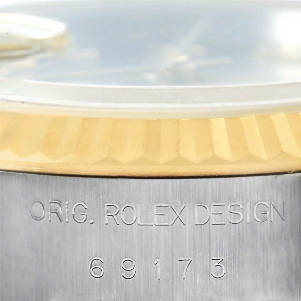 This image shows the side view of a Rolex Datejust 69173 Women's Stainless Steel Grey Dial 69173 Women's Stainless Steel Grey Dial watch, highlighting the fluted bezel and engraved model number 69173.