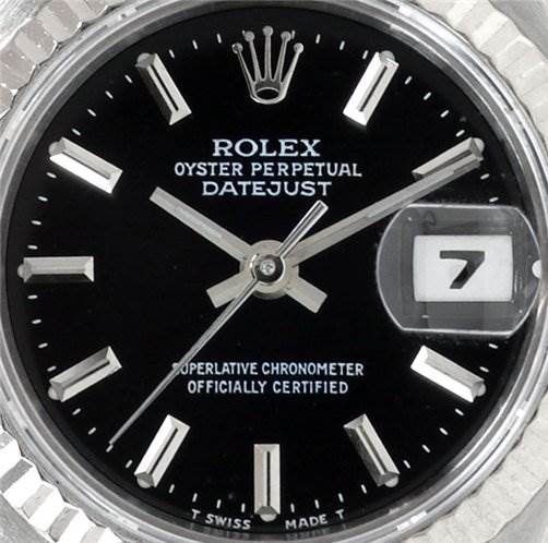 This image shows a close-up of the face of a Rolex Datejust 69174 Women's Stainless Steel Black Dial 69174 Women's Stainless Steel Black Dial watch, highlighting the dial, hands, date window, and logo.