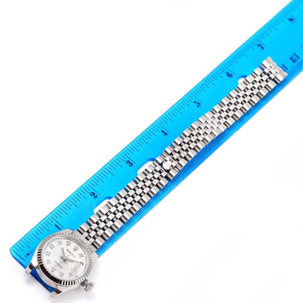 The image shows a Rolex Datejust 179174 Women's Stainless Steel Silver Dial 179174 Women's Stainless Steel Silver Dial watch laid flat alongside a blue ruler for scale.