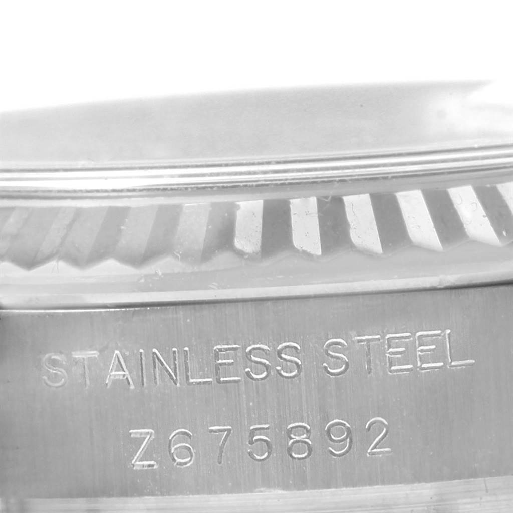 The image shows a close-up view of the case back of a Rolex Datejust 179174 Women's Stainless Steel Silver Dial 179174 Women's Stainless Steel Silver Dial watch, focusing on the stainless steel material and serial number.