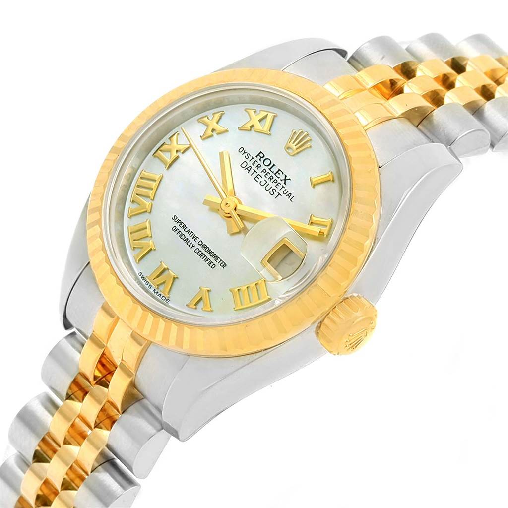 This image shows a Rolex Datejust 179173 Women's Steel and Gold (two tone) Mother of Pearl Dial 179173 Women's Steel and Gold (two tone) Mother of Pearl Dial watch viewed from an angle showcasing the face, bezel, crown, and part of the bracelet.