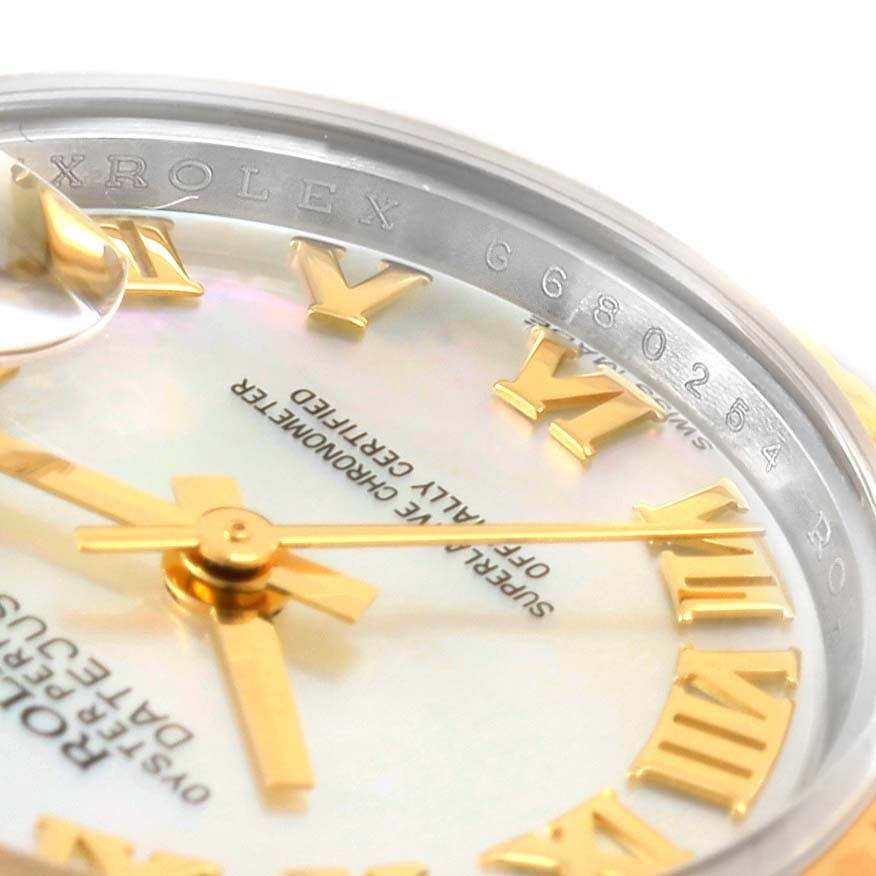 This close-up shot of the Rolex Datejust 179173 Women's Steel and Gold (two tone) Mother of Pearl Dial 179173 Women's Steel and Gold (two tone) Mother of Pearl Dial shows the dial, part of the lettering, and the inner bezel with serial numbers.
