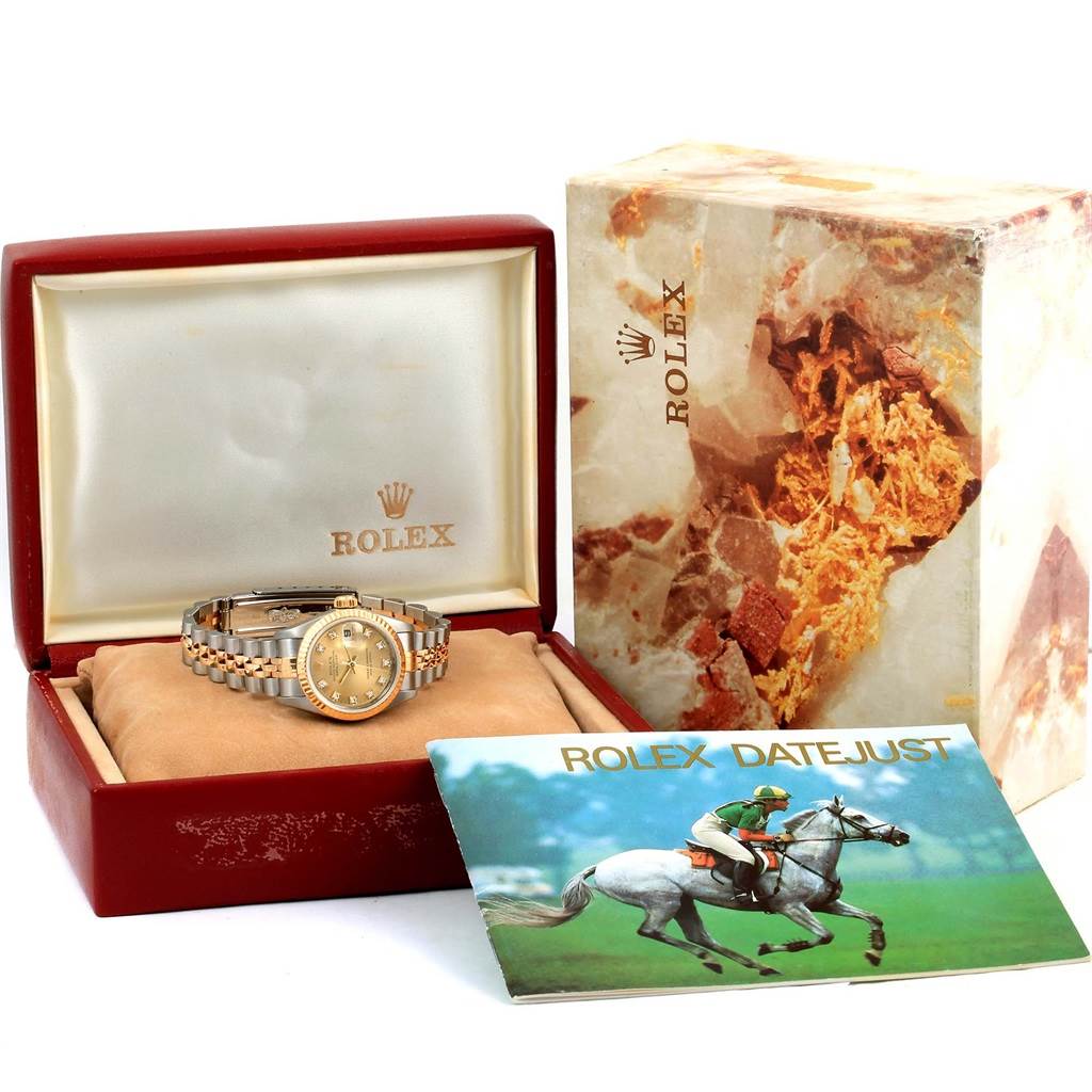 The Rolex Datejust 69173 Women's Stainless Steel Champagne Dial 69173 Women's Stainless Steel Champagne Dial watch is shown in its box, accompanied by an outer packaging and a booklet.