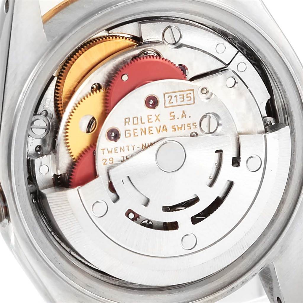 The image displays the interior mechanical movement of a Rolex Datejust 69173 Women's Stainless Steel Grey Dial 69173 Women's Stainless Steel Grey Dial watch, showcasing gears and the rotor.