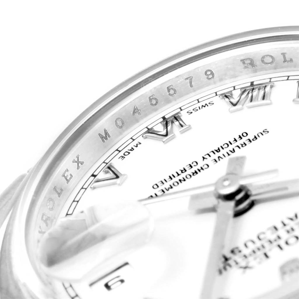 Close-up view of the Rolex Datejust 179160 Women's Stainless Steel White Dial 179160 Women's Stainless Steel White Dial watch showing part of the face, bezel with serial number, and some Roman numeral hour markers.