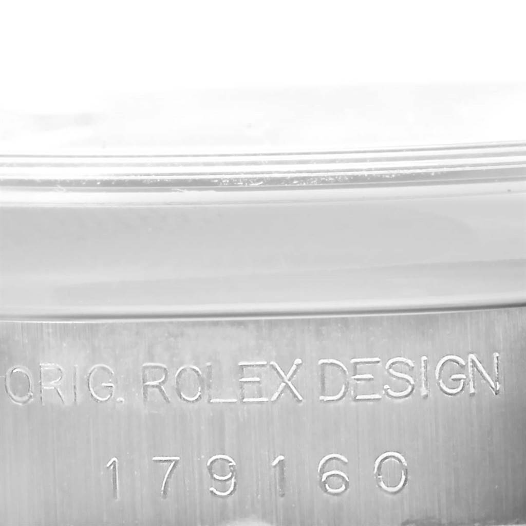 This close-up image shows the engraved serial number on the side of the Rolex Datejust 179160 Women's Stainless Steel White Dial 179160 Women's Stainless Steel White Dial watch case.