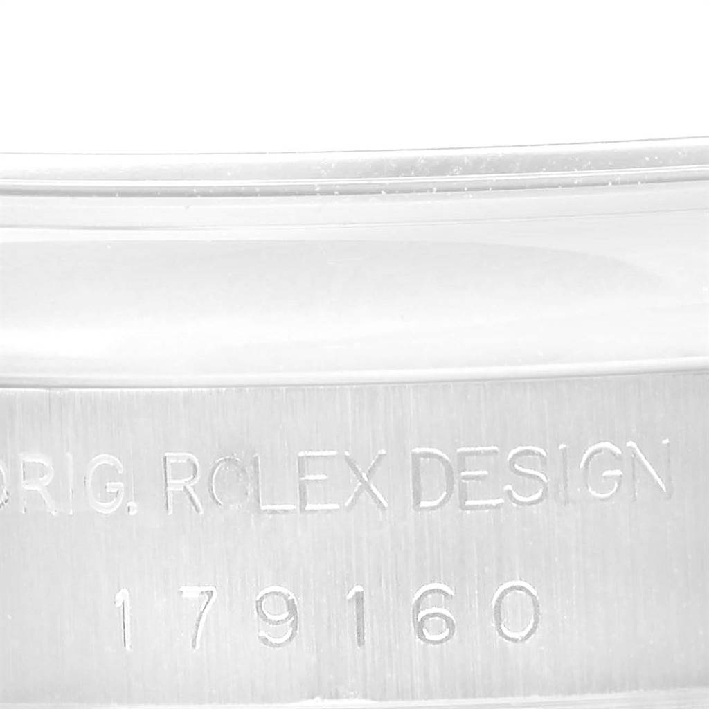 This close-up image shows the side of the casing of a Rolex Datejust 179160 Women's Stainless Steel Pink Dial 179160 Women's Stainless Steel Pink Dial watch, featuring engraved text and the model number.