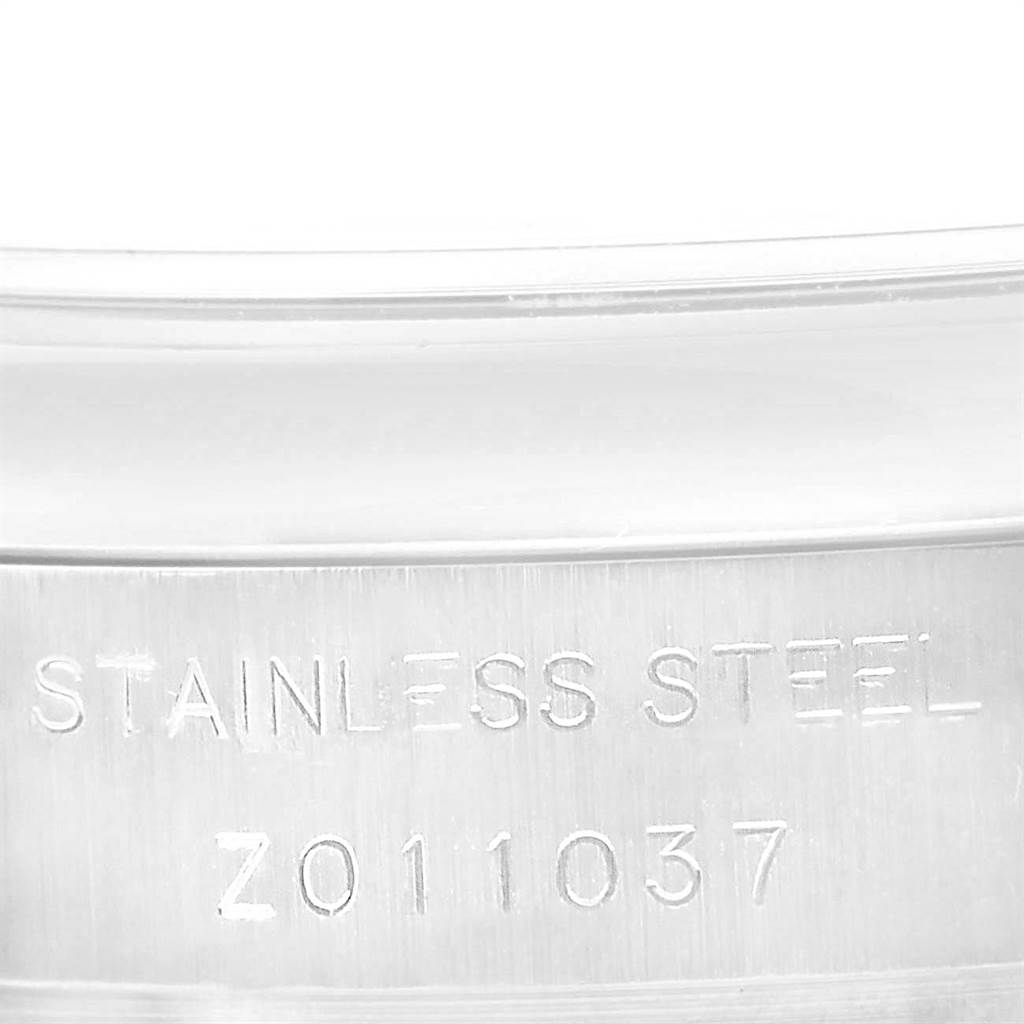 The image shows a close-up of the stainless steel casing of a Rolex Datejust 179160 Women's Stainless Steel Pink Dial 179160 Women's Stainless Steel Pink Dial watch, focusing on the engraved serial number.