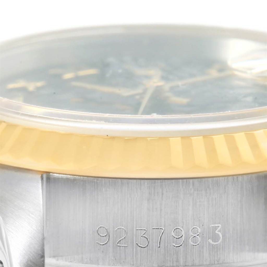The image shows a close-up of the bezel, partially covered watch face, and the serial number of a Rolex Datejust 69173 Women's Steel and Gold (two tone) Black Dial 69173 Women's Steel and Gold (two tone) Black Dial watch.
