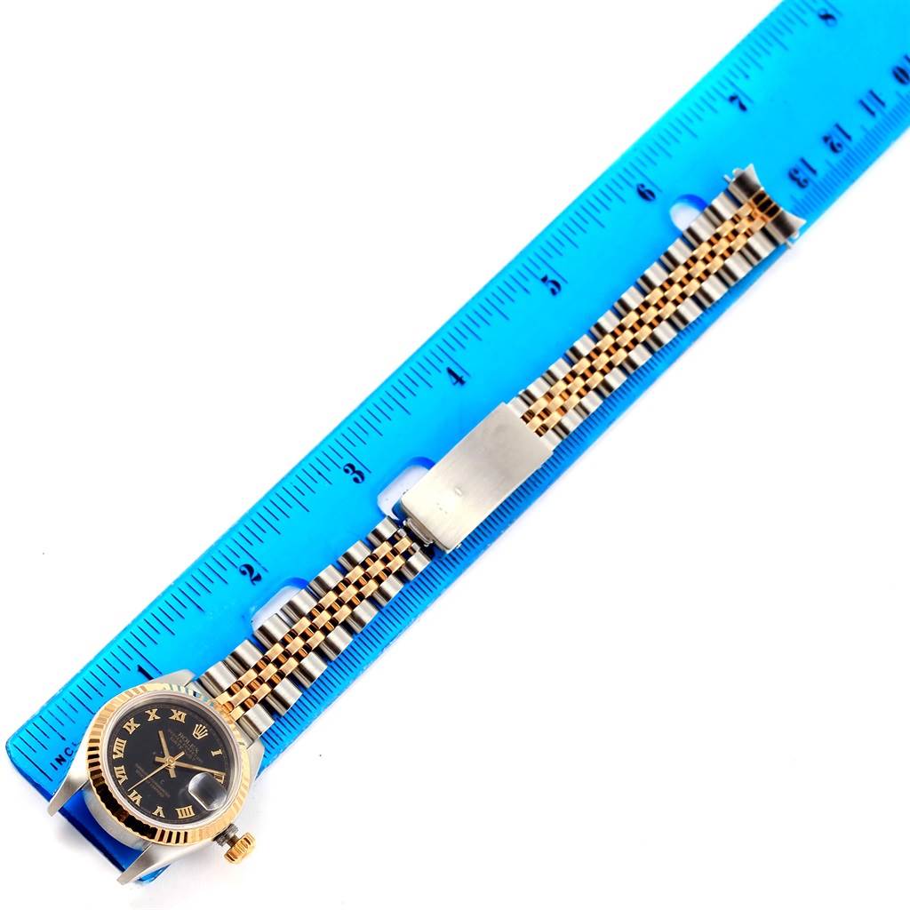 The image shows a Rolex Datejust 69173 Women's Steel and Gold (two tone) Black Dial 69173 Women's Steel and Gold (two tone) Black Dial watch laid flat next to a ruler, highlighting its bracelet and face.