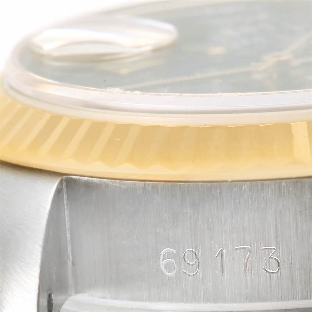 The image shows a close-up of the side of a Rolex Datejust 69173 Women's Steel and Gold (two tone) Black Dial 69173 Women's Steel and Gold (two tone) Black Dial watch, focusing on the model number engraving and a portion of the bezel and crystal.