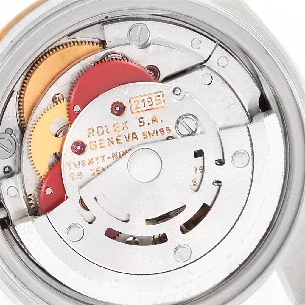 This image shows a close-up of the internal mechanism of a Rolex Datejust 69173 Women's Steel and Gold (two tone) Black Dial 69173 Women's Steel and Gold (two tone) Black Dial watch, highlighting its intricate gears and components.