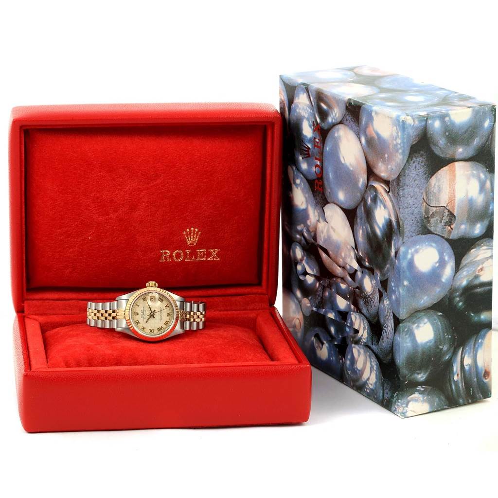 The Rolex Datejust 69173 Women's Steel and Gold (two tone) Beige Dial 69173 Women's Steel and Gold (two tone) Beige Dial watch is displayed in an open red box, with a decorative outer box partially visible next to it.