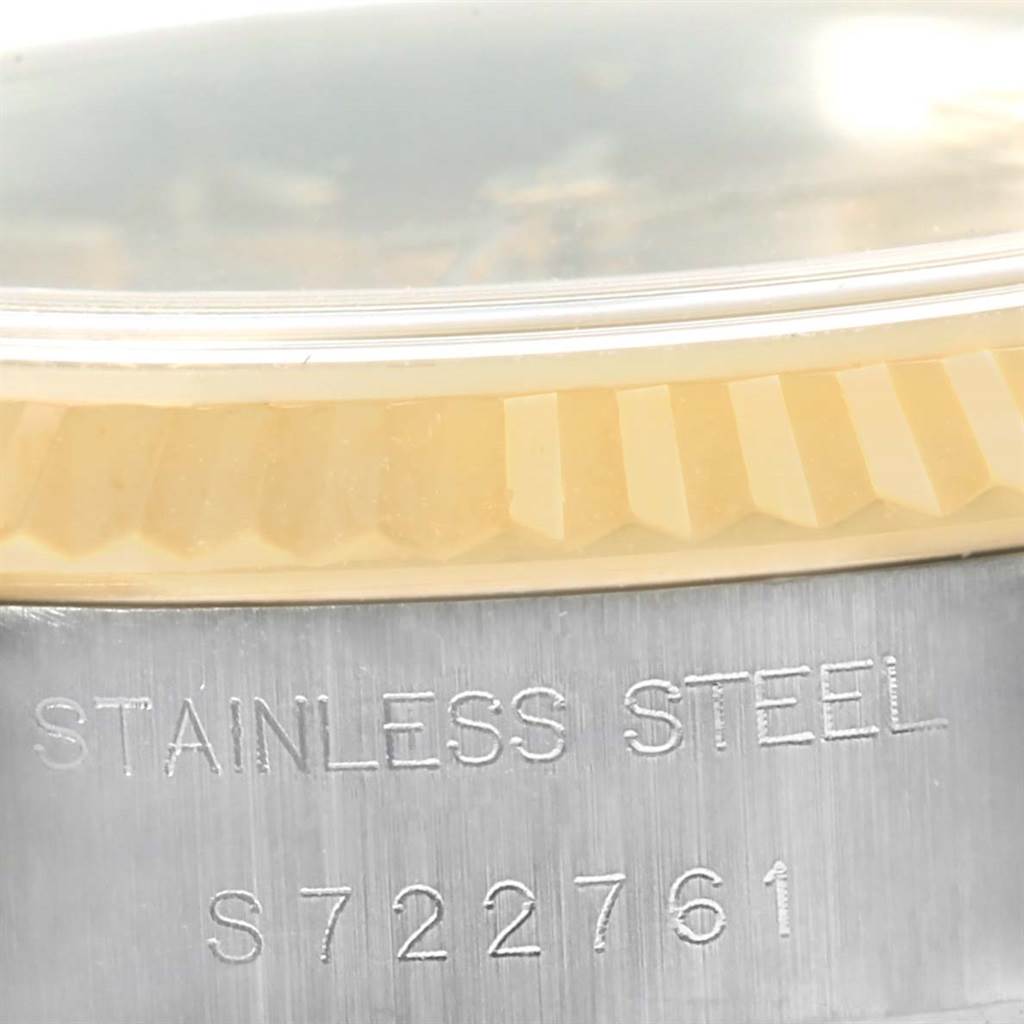 This close-up image of a Rolex Datejust 69173 Women's Stainless Steel Champagne Dial 69173 Women's Stainless Steel Champagne Dial watch shows the stainless steel casing and part of the fluted bezel.